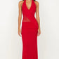 Woman wearing a red halter neck gown on a white background