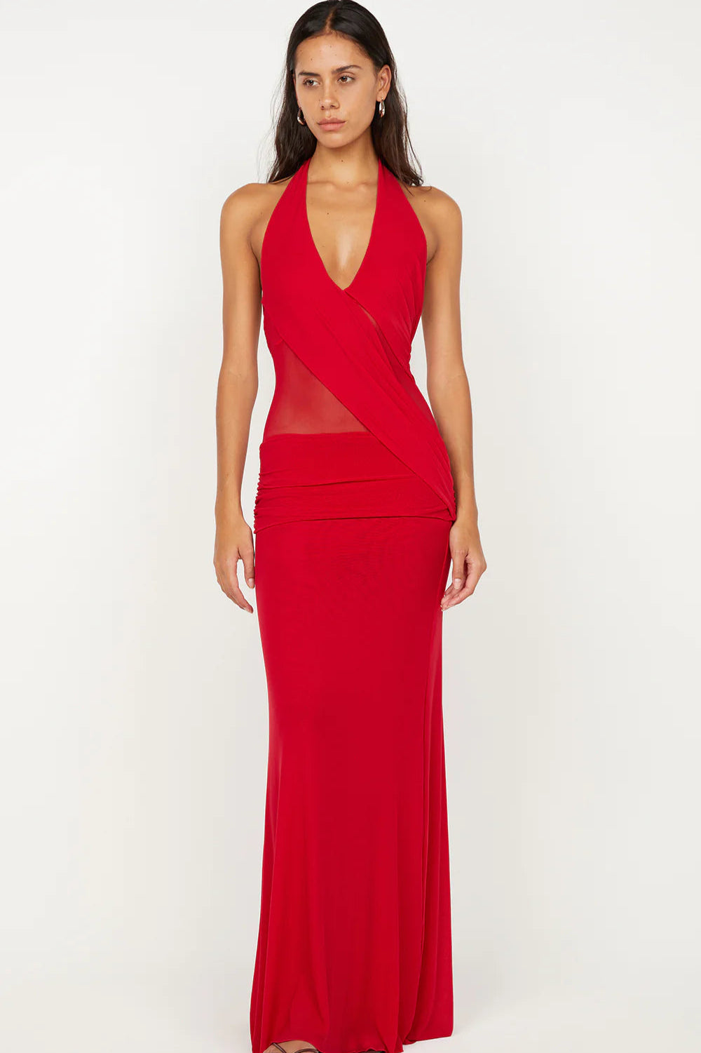 Woman wearing a red halter neck gown on a white background